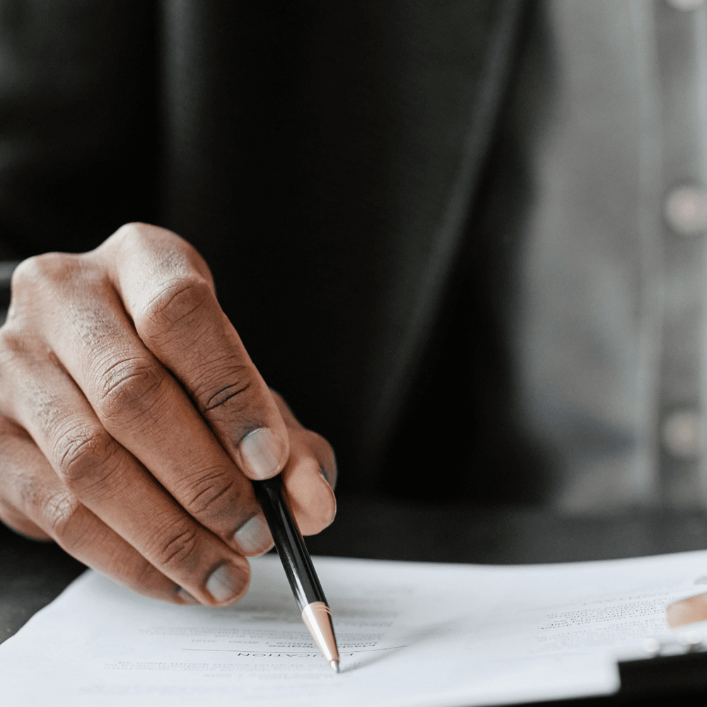 man writing on paper