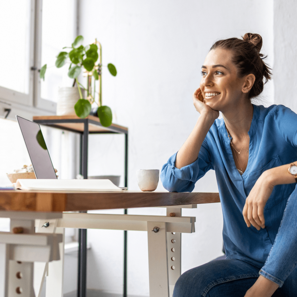 woman sitting at desk smiling